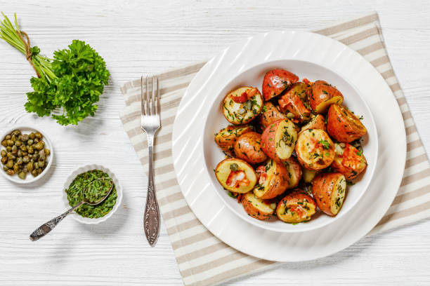 istock Herbs Garlic Potatoes in white bowl, top view 1532792032