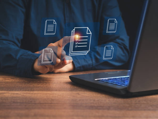 istock A businessman working at a laptop and digital documents with checkbox lists on a virtual screen. 1532798984