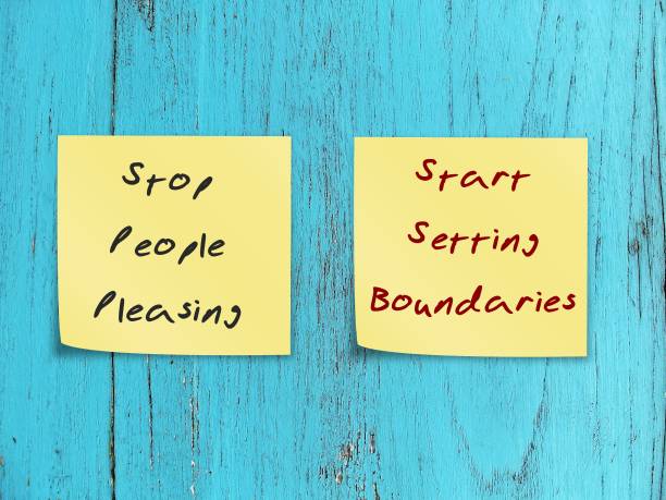 Two notes stick on blue wood background STOP PEOPLE PLEASING - START SETTING BOUNDARIES, concept of people pleaser start to let go the need to be perfect, approval addiction and start to set boundary