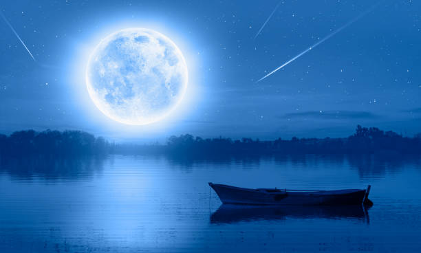 istock Birds silhouettes flying over the lake with full moon 1532849699