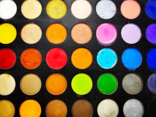Different colors of eyeshadow in a palette in the cosmetics store.