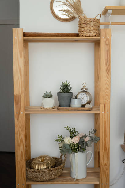 istock Wooden shelving unit with different home related objects in modern interior 1532886914