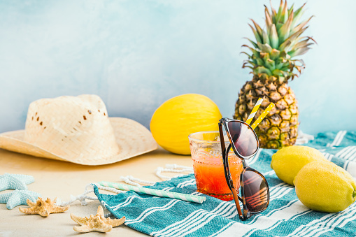 Summer holiday concept, summer accessories with refreshing juice and fresh fruits