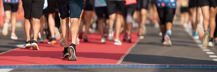 Marathon running race, people feet on city road