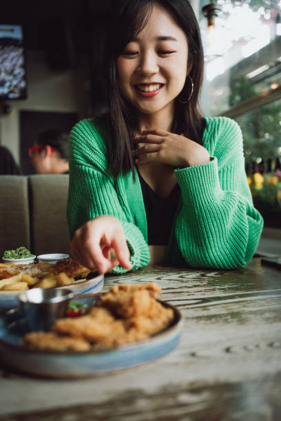 istock Asian woman eating fried chicken in a restaurant 1532917128