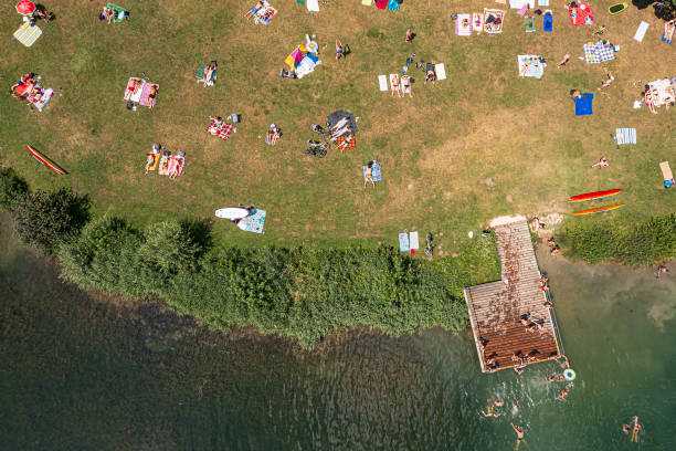 istock Lake shore with people from above 1532918720