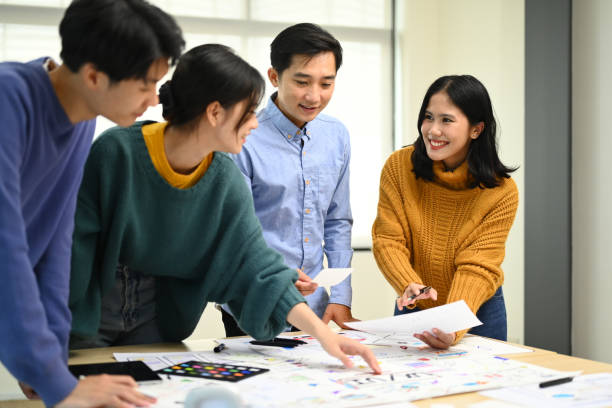 istock Team of creative people brainstorming and discussing for mobile application software design project at office. 1532924476