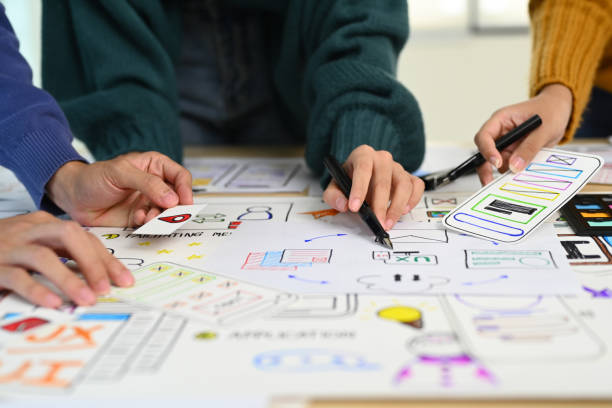 istock Male and female creative web designer brainstorming and discussing for mobile application software design project at office. 1532925007
