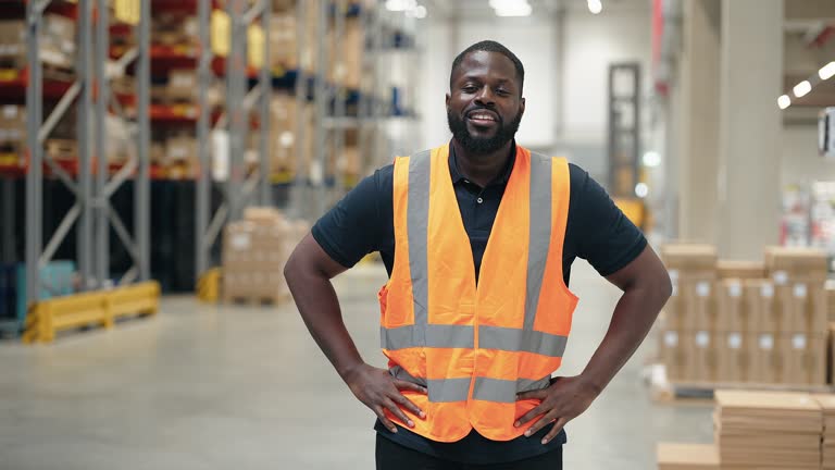 Portrait of confident african man working in distribution warehouse