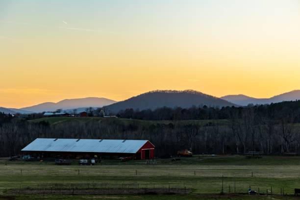 istock Picturesque rural landscape a farm surrounded by rolling hills 1532945257