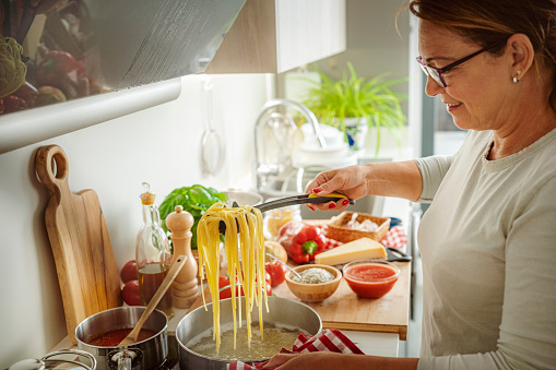 Woman cooking Italian spaghetti recipe