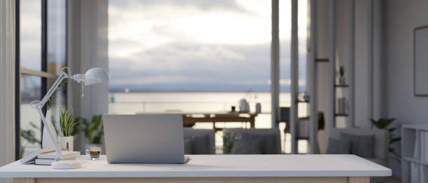 istock Back view of a modern workspace with a laptop and office supplies on a table 1532954154