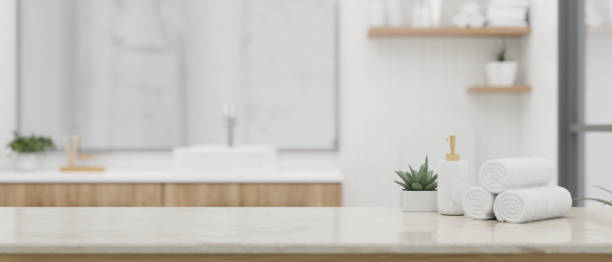 istock A shampoo bottle, towels, and copy space on a white tabletop in a beautiful white bathroom. 1532954682