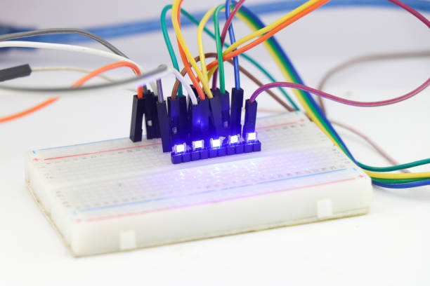 Blue light emitted by the SMD Led or a light emitting diode connected in parallel on a breadboard. Glowing LED on a breadboard