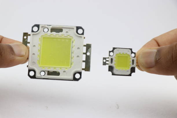 istock High power SMD white lighting LEDs of different sizes held in the hand isolated on white background 1532970230