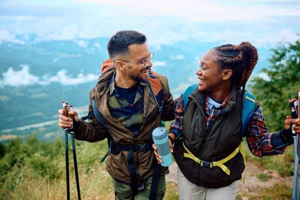 istock Happy couple talking during water break while hiking in the mountains. 1532983495