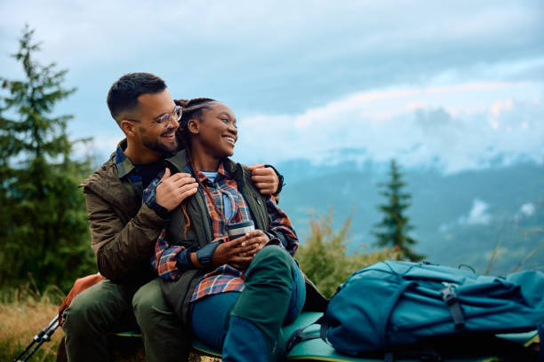 istock Carefree couple enjoying the view while taking a break during hiking in nature. 1532986221