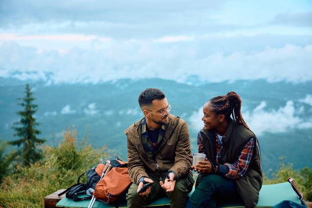 istock Young adventurous couple talking while relaxing father hiking in the mountains. 1532986778