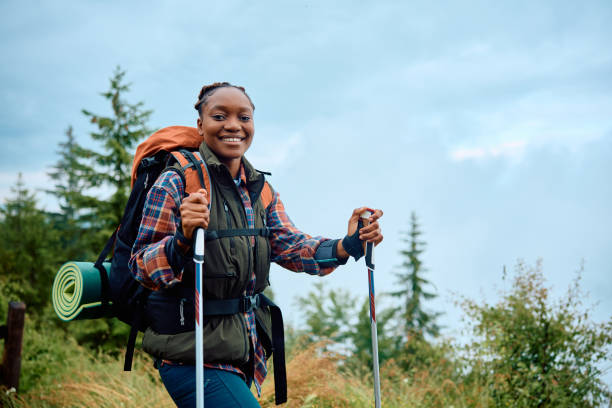 istock Happy black female hiker in nature looking at camera. 1532987900
