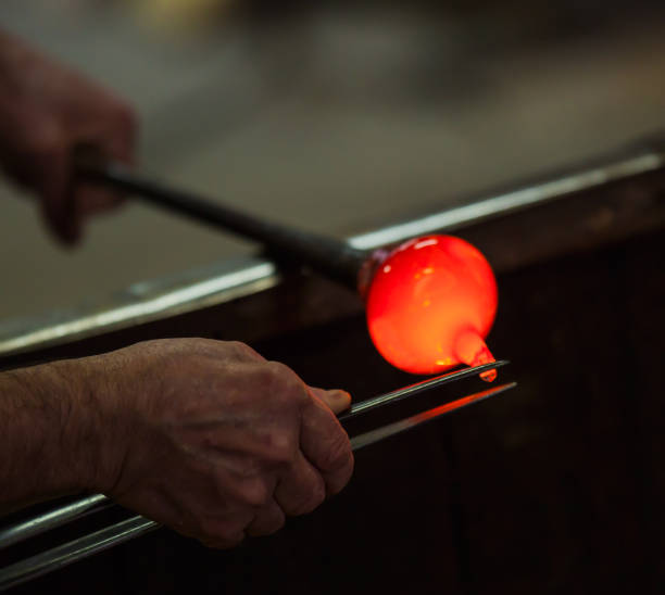 istock Glass blower at work shaping molten glass, Murano 1532992128