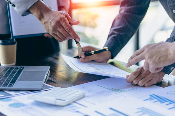 istock Analyzing business finance report on financial graph document during discussion at company meeting showing successful teamwork. Business Accounting Concepts close up pictures 1533005275
