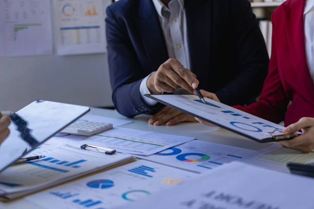 istock Analyzing business finance report on financial graph document during discussion at company meeting showing successful teamwork. Business Accounting Concepts close up pictures 1533005276