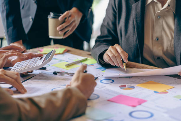 istock Analyzing business finance report on financial graph document during discussion at company meeting showing successful teamwork. Business Accounting Concepts close up pictures 1533005797