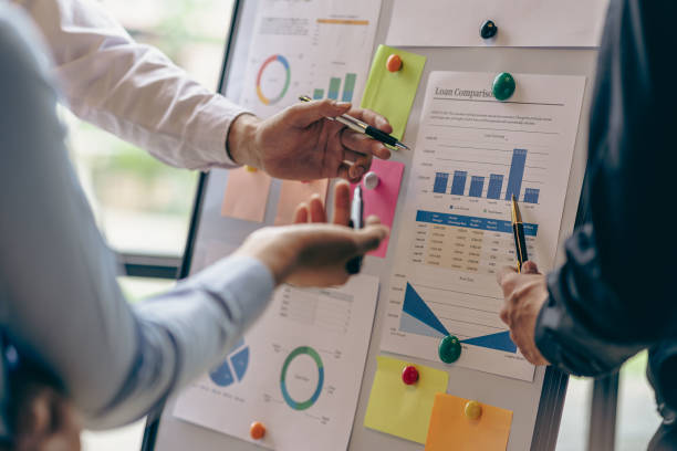 istock Analyzing business finance report on financial graph document during discussion at company meeting showing successful teamwork. Business Accounting Concepts close up pictures 1533005811