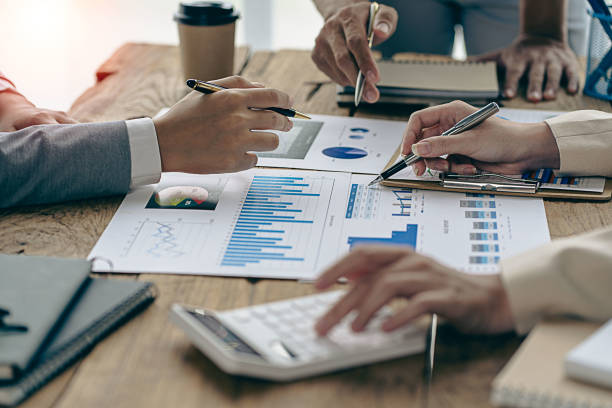 istock Analyzing business finance report on financial graph document during discussion at company meeting showing successful teamwork. Business Accounting Concepts close up pictures 1533006321