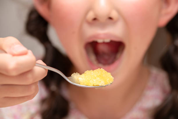 Close up of a little girl with chocolate on her mouth while smiling at the camera