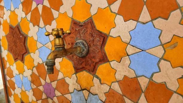 istock Antique golden faucet with mosaic pattern wall 1533102943
