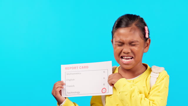 Report card, fail and girl crying in studio with presentation of grades, bad rating or problem in education. School, student or sad, unhappy or upset Indian child show results on a blue background