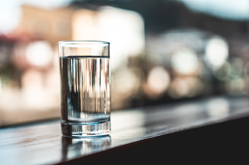 Close up of a Glass of Drinking Water on White Table