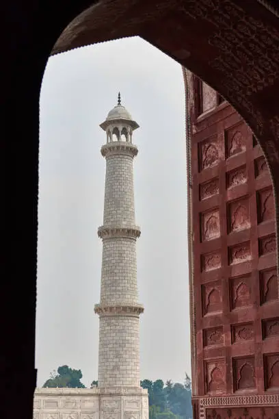 Photo of Minaret of Taj Mahal white marble mausoleum landmark in Agra, Uttar Pradesh, India, white tower