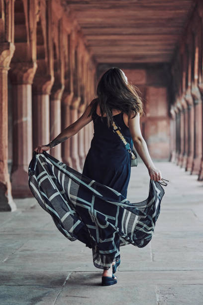 donna dell'asia orientale in vestito nero che danza con sciarpa traslucida tra le colonne del tempio antico - taj mahal mahal door temple foto e immagini stock