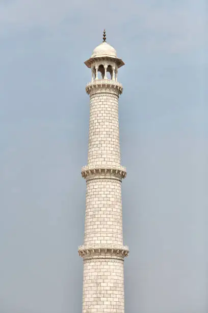 Photo of Minaret of Taj Mahal white marble mausoleum landmark in Agra, Uttar Pradesh, India, white tower