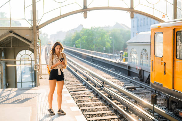 istock Woman using smartphone  while waiting for the subway train 1533252853