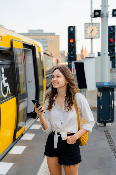 istock Woman using smartphone  while waiting for the subway train 1533256993