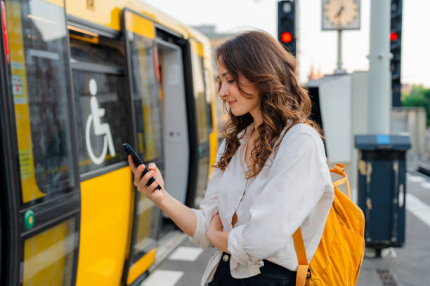 istock Woman using smartphone  while waiting for the subway train 1533256994