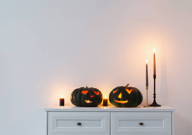 istock black halloween pumpkin with burning candles in white interior 1533266496