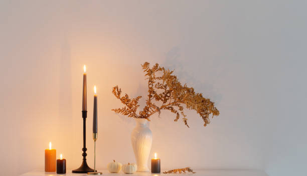 istock beautiful autumn home decor with burning candles in white interior 1533267009