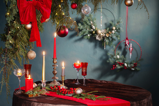 red  and golden christmas decor on table on dark background