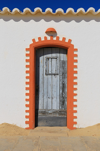 Old whitewashed facades in Tavira Island in Algarve region, Portugal