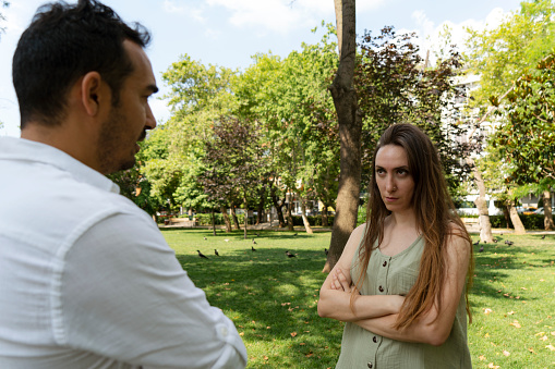 Young couple having an argument at park