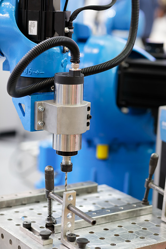 Automated robotic drilling and tapping machine. Close up photo. Selective focus.