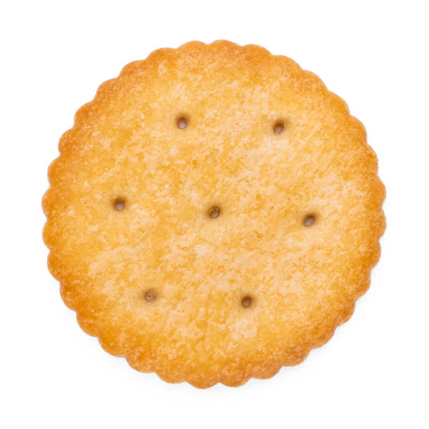 istock Healthy whole wheat cracker on white background. Stack of Saltine crackers isolated on white background. Round crackers. 1533355385