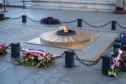Paris, France - June 25, 2023 : View of the eternal flame at the tomb of the unknown soldier at the Arc de Triomphe in Paris France