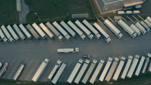 Truck riding on road to depot parking aerial view