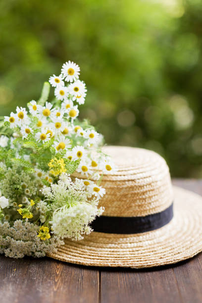 istock Straw hat boater and wildflowers bouquet 1533360848
