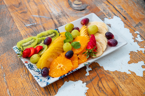 Tropical and continental fruit sliced and offered on tray in fine dining